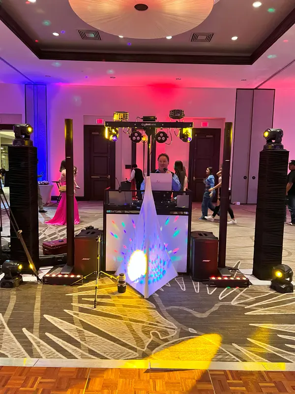 Ballroom with colored uplighting around the Chris James DJ setup