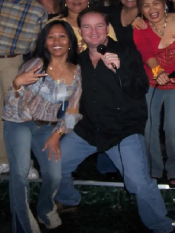 Chris James with the microphone among party guests